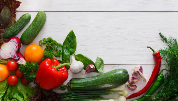 istock Fresh vegetables border on white wood background with copy space 694481194