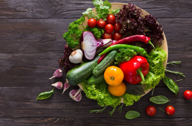 istock Plenty of fresh vegetables on wooden background with copy space 694481474
