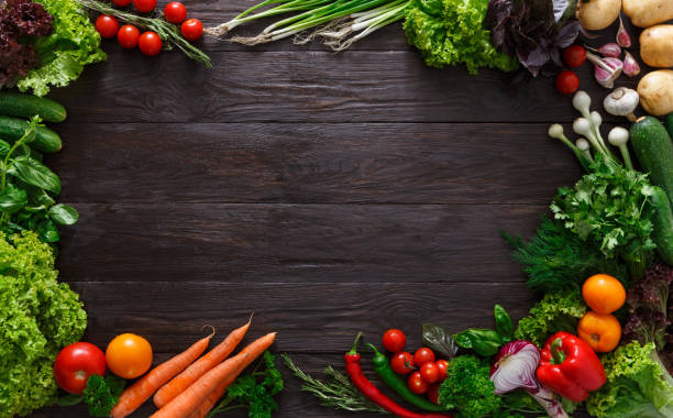 istock Frame of fresh vegetables on wooden background with copy space 694481518