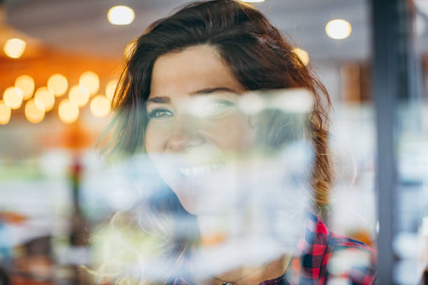 istock Happy Young Woman Looking Out Window View Through Glass 694481534