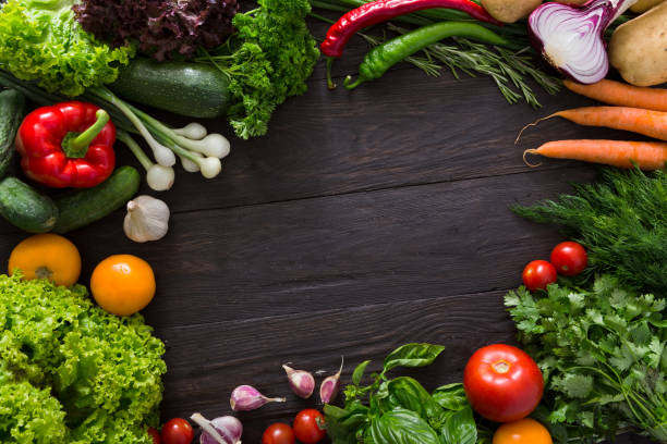 istock Frame of fresh vegetables on wooden background with copy space 694481660