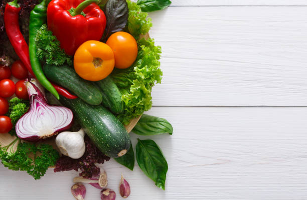 istock Border of fresh vegetables on wooden background with copy space 694481916