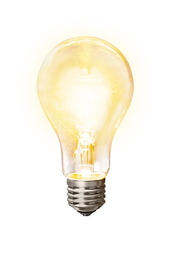 Glowing yellow light bulb on white