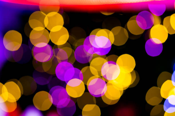 istock Abstract Yellow Purple lights bokeh background 694489076