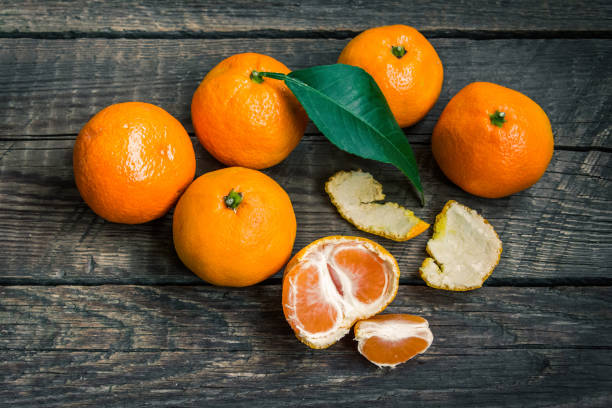 istock Mandarins on a wooden background 694491902