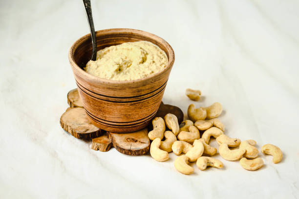 Cashew sauce, raw vegan cheese from nuts with nutritional yeast. Dairy free. Healthy or diet food concept.  Rustic stock photo