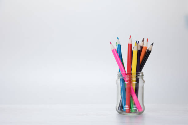 istock Glass jar filled with colorful pencil crayons 694507672