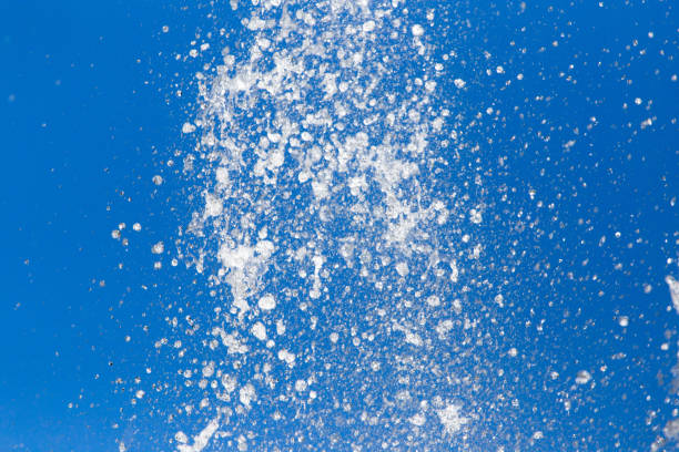 istock Splashing water against the blue sky 694508932