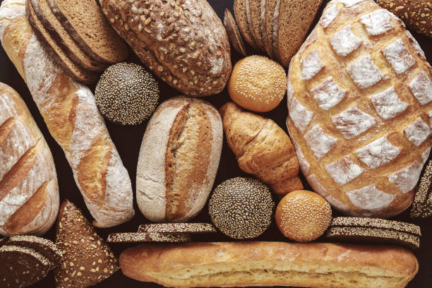 istock Bread background, top view of white, black and rye loaves 694508970