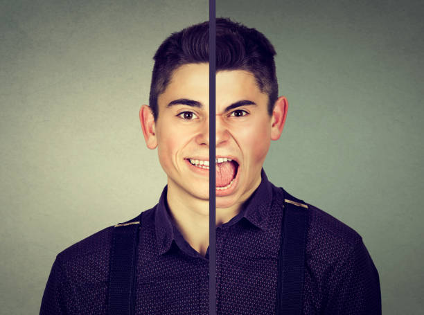 istock Bipolar disorder concept. Young man with double face expression isolated on gray background 694509344