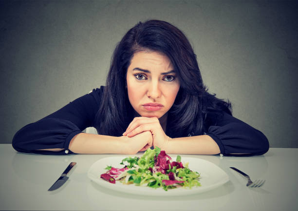 dieting habits changes. woman hates vegetarian diet - plate changing imagens e fotografias de stock