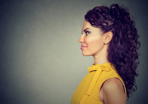 istock side profile of beautiful woman 694511410