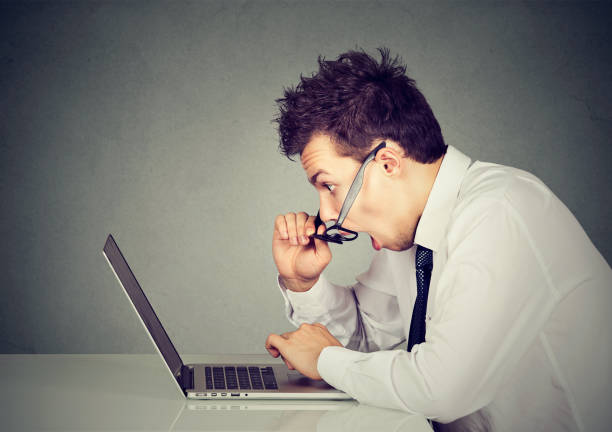 istock Shocked surprised young man looking at laptop computer amazed with open mouth 694511672