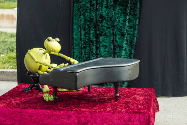 Barcelona, Spain - May 14, 2017: Performance of a frog puppet playing piano on the street in Barcelona, Spain.