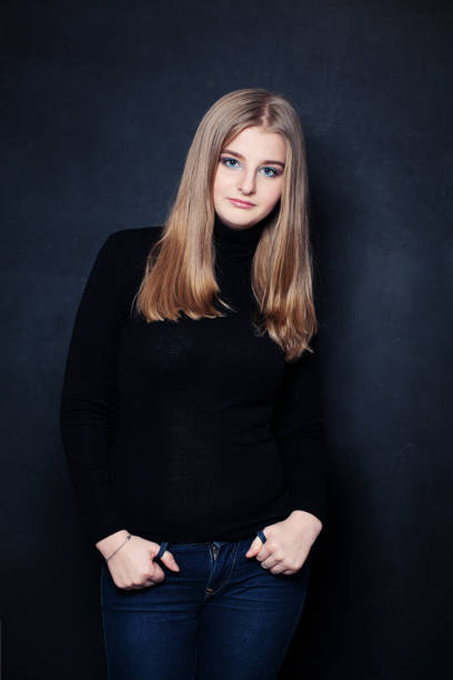 istock Young Girl on Dark Background 694518136