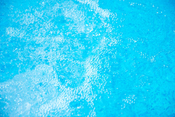 istock Blue clear fresh Water in hot tub. Spa massage background. 694518496