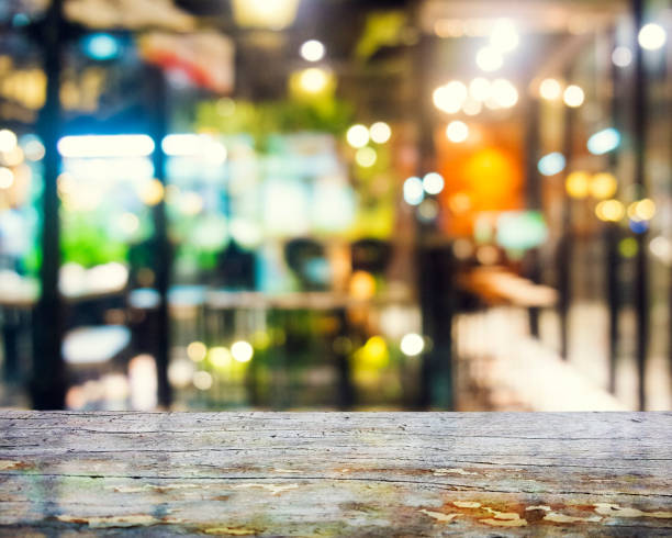 istock image of wooden table in front of abstract blurred background 694532550