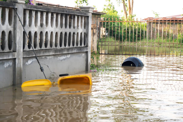 Garbage bin float. Flooding in town. Natural disaster.