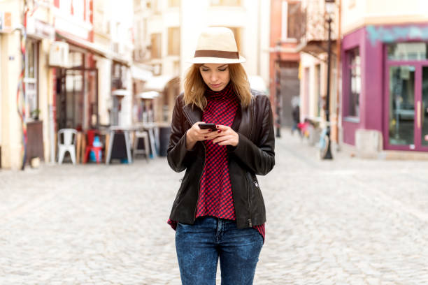 istock Smiling woman with a phone 694539264