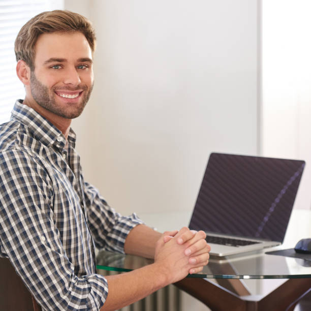 istock Handsome young adult man smiling at camera over his shoulder 694542120