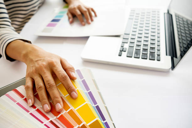 istock Graphic design and color swatches and pens on a desk. Architectural drawing with work tools and accessories. 694542192