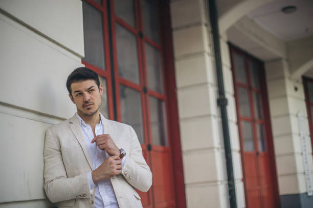istock Cute man in suit downtown 694545474