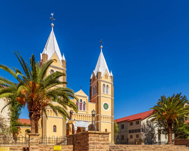 istock Catholic Saint Mary Church with palms and blue sky  in background, Windhoek, Namibia 694545882