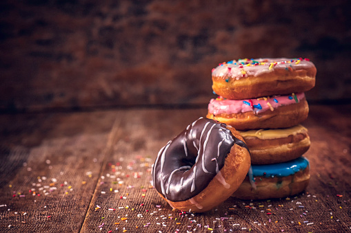 Variation of delicious donuts with colored icing and chocolate.