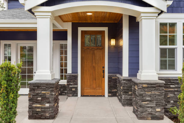 New Luxury Home Exterior Detail Patio And Front Door With Arch And Columns  Stonework Graces The Bottom Of The Columns And House While White Columns  And Archway Provide A Stately Welcome Stock