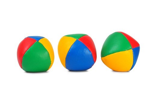 Three colorful juggling balls against white background