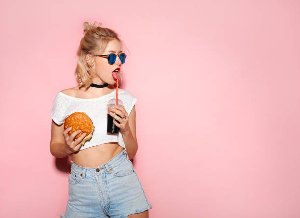 istock Pretty woman having fast food 694553246