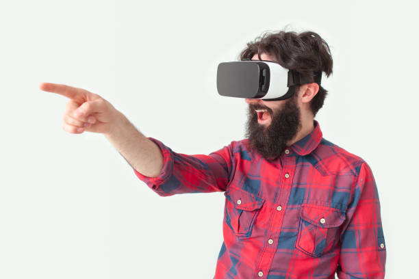 istock Bearded man touching air in VR headset 694553622
