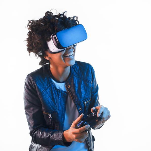 istock Cheerful woman playing in VR headset 694553740