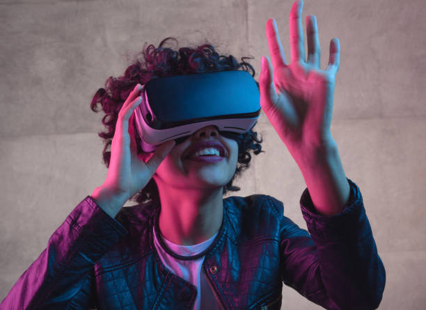 istock Woman touching air in VR goggles 694555384