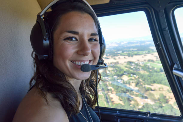 istock Young woman flying in helicopter 694556184