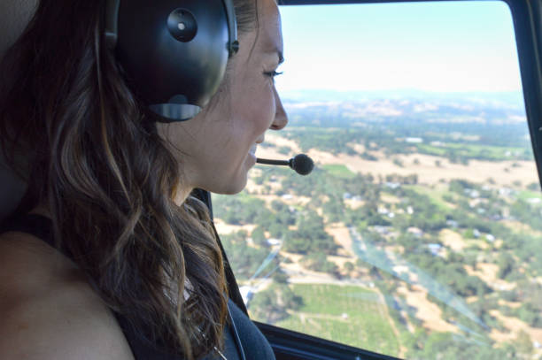 istock Young woman flying in helicopter 694556638