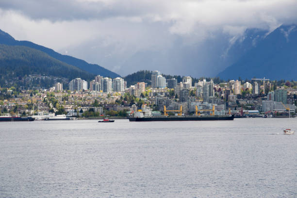 istock A cargo ship passing by North Vancouver on a cloudy day in spring. 694562766