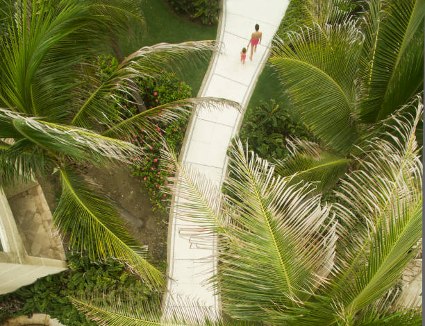 Mother walking with son at a beach resort