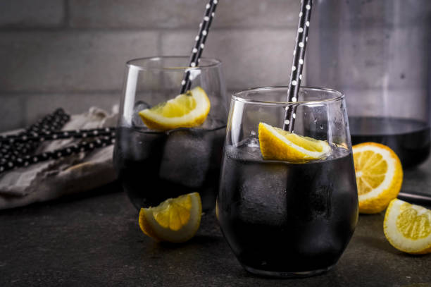 Black lemonade with ice and lemon stock photo