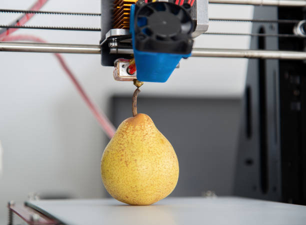 One ripe juicy pear.3d printer working of the device during the processes stock photo