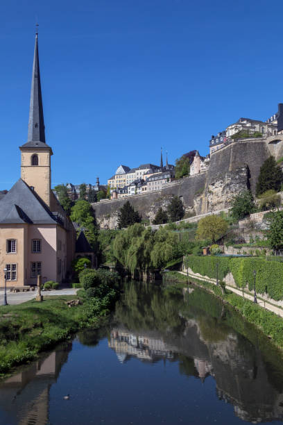 Luxembourg City - City of Luxembourg Luxembourg City - Ville de Luxembourg. St John Neimenster and the walls of the old town viewed from the Grund area of the city. petrusse stock pictures, royalty-free photos & images