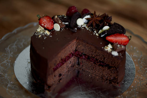 istock The chocolate cherry cake, decorated with strawberries, biscuits and strawberry shortcake. A masterpiece of culinary art 694570306