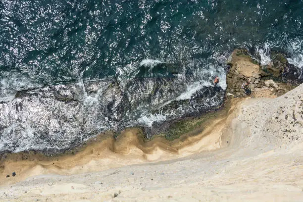 Photo of Aerial view of sea and a stone wall