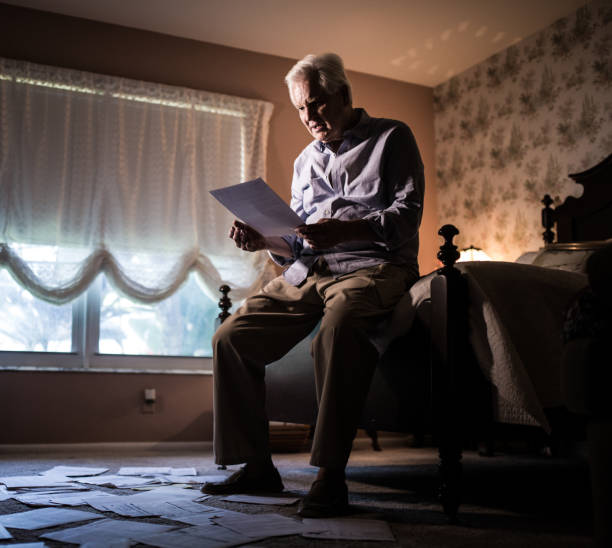 istock Senior man receiveing bank debt documents 694584924