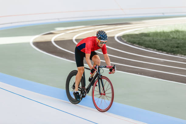 istock Racing cyclist on velodrome outdoor 694585134