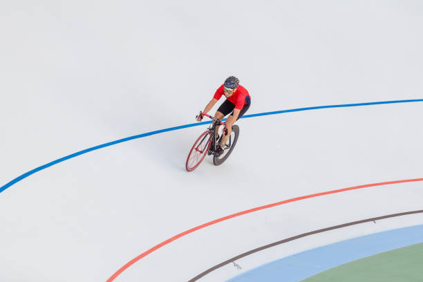 istock Young professional cyclist on a velodrome 694585338