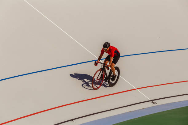 istock Racing cyclist on velodrome outdoor 694585584
