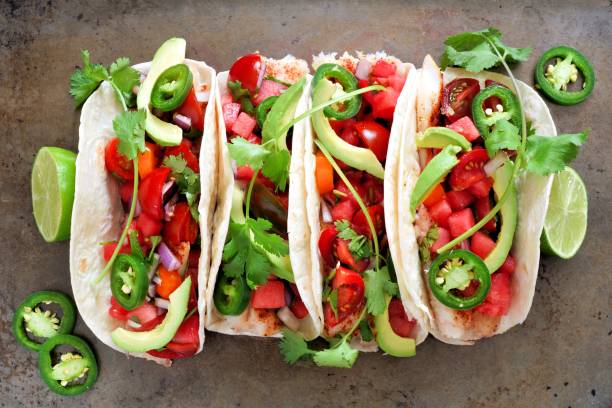 istock Fish tacos with watermelon salsa and avocados, on metallic background 694588206