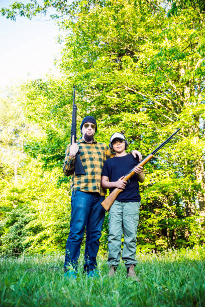 istock Boy being taught how to shoot a rifle safely 694588226
