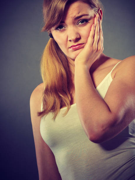 istock Woman suffering from tooth pain 694597956